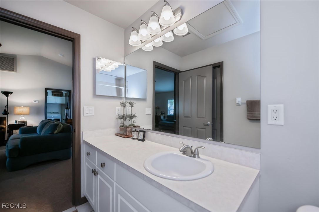 4108 13th Street Southwest Lehigh Acres, FL 33976 - Photo 21 of 48 a en suite bathroom with a double vanity sink and a mirror