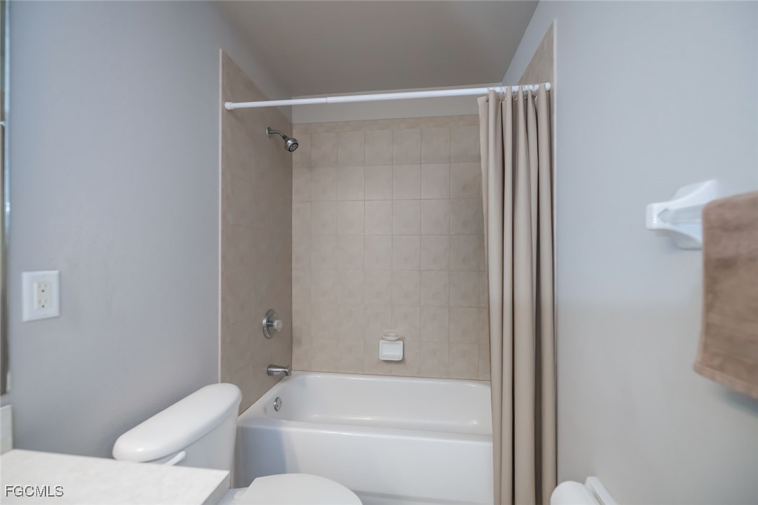 4108 13th Street Southwest Lehigh Acres, FL 33976 - Photo 23 of 48 a bathroom with a toilet and a bathtub