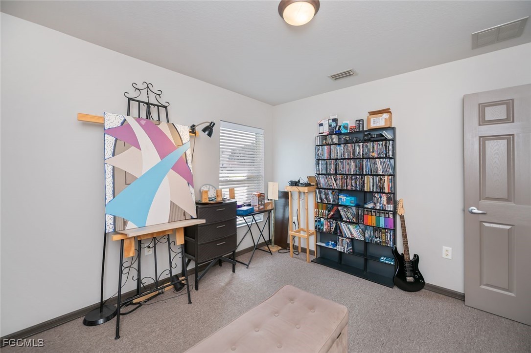 4108 13th Street Southwest Lehigh Acres, FL 33976 - Photo 26 of 48 a room with lots of furniture and a book shelf