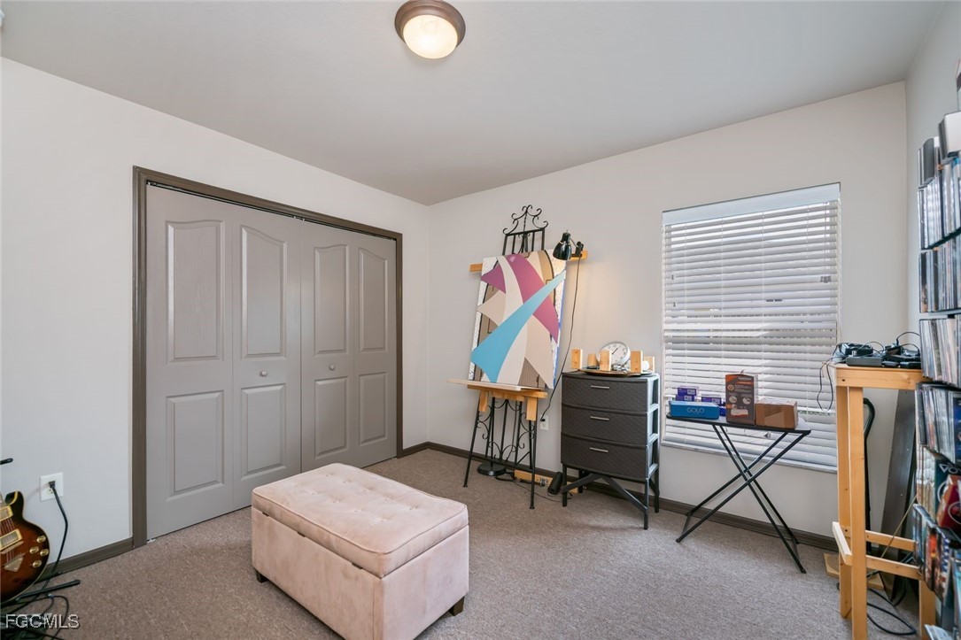4108 13th Street Southwest Lehigh Acres, FL 33976 - Photo 27 of 48 a living room with furniture and a window