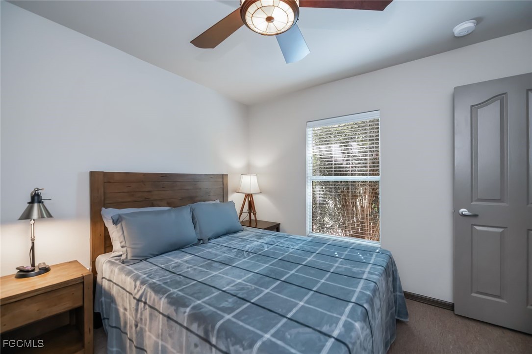4108 13th Street Southwest Lehigh Acres, FL 33976 - Photo 30 of 48 a bedroom with a bed and a window