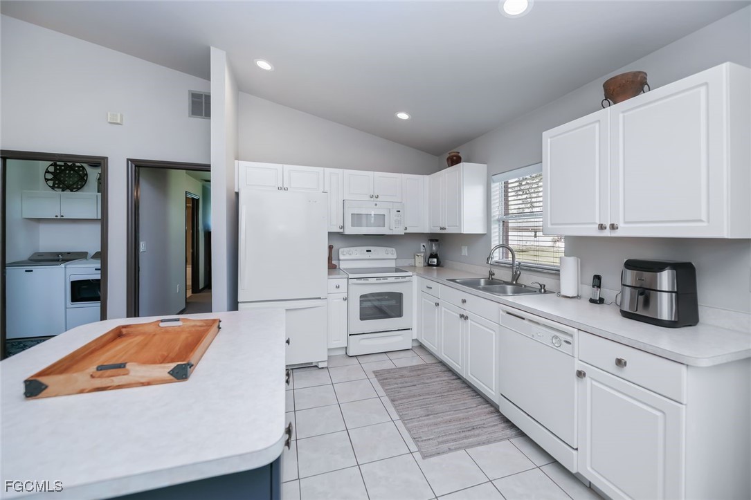 4108 13th Street Southwest Lehigh Acres, FL 33976 - Photo 3 of 48 a kitchen with stainless steel appliances granite countertop a white refrigerator a stove a sink and white cabinets