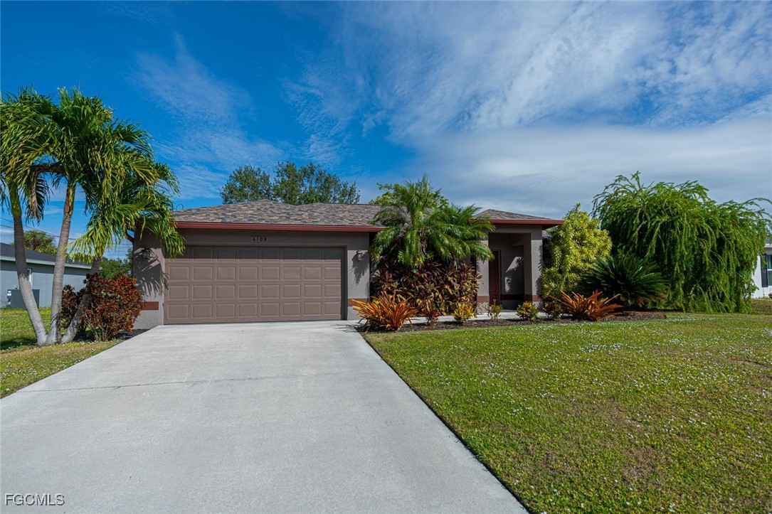 4108 13th Street Southwest Lehigh Acres, FL 33976 - Photo 33 of 48 a front view of a house with a yard and a garage