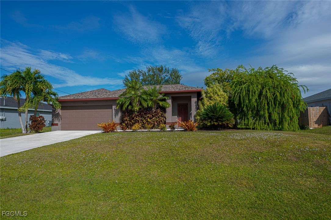 4108 13th Street Southwest Lehigh Acres, FL 33976 - Photo 34 of 48 a front view of a house with garden