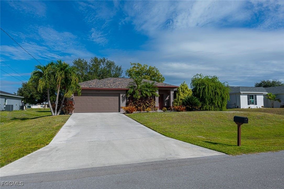 4108 13th Street Southwest Lehigh Acres, FL 33976 - Photo 37 of 48 a front view of a house with a yard and garage