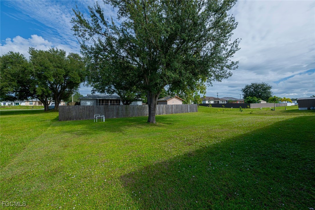 4108 13th Street Southwest Lehigh Acres, FL 33976 - Photo 38 of 48 a view of a house with a big yard
