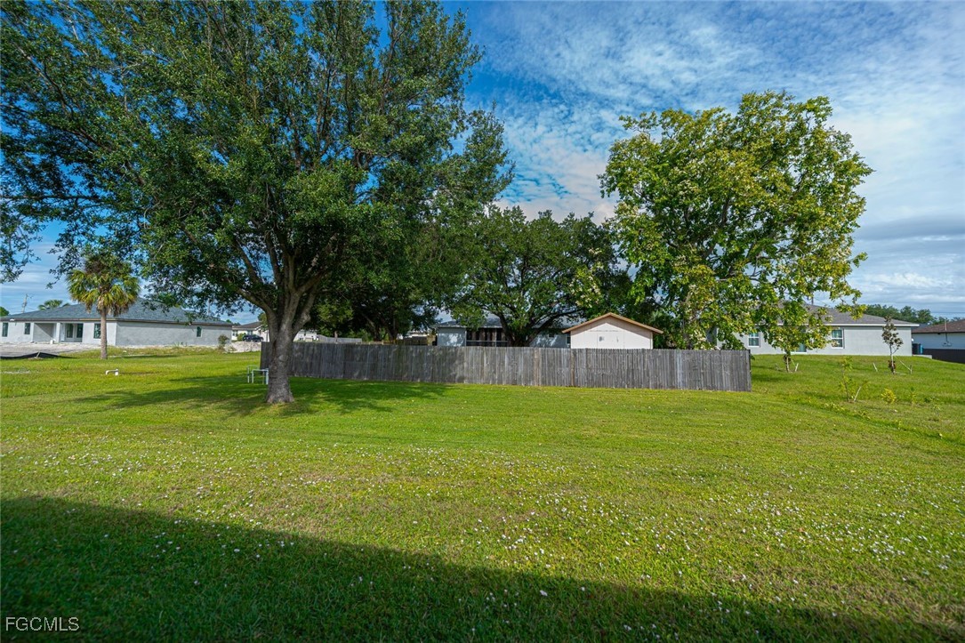 4108 13th Street Southwest Lehigh Acres, FL 33976 - Photo 39 of 48 a view of a big yard next to a large tree