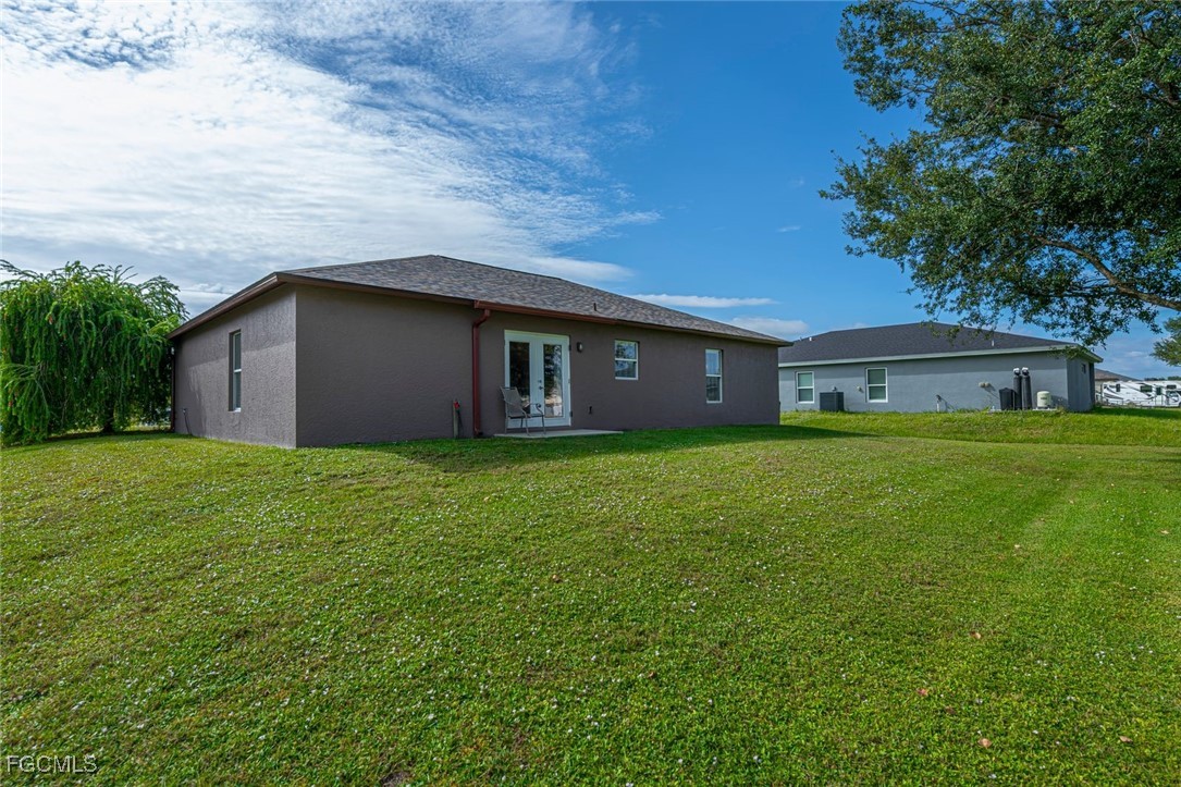 4108 13th Street Southwest Lehigh Acres, FL 33976 - Photo 40 of 48 a front view of house with yard and green space