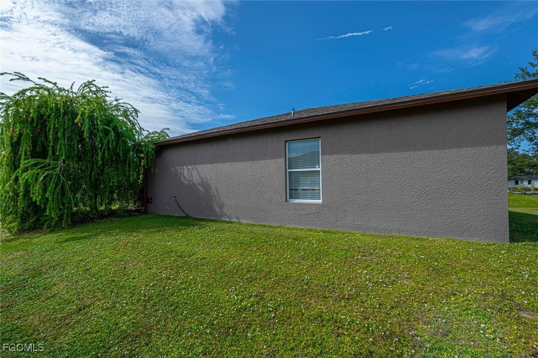 4108 13th Street Southwest Lehigh Acres, FL 33976 - Photo 42 of 48 a backyard of a house with lots of green space