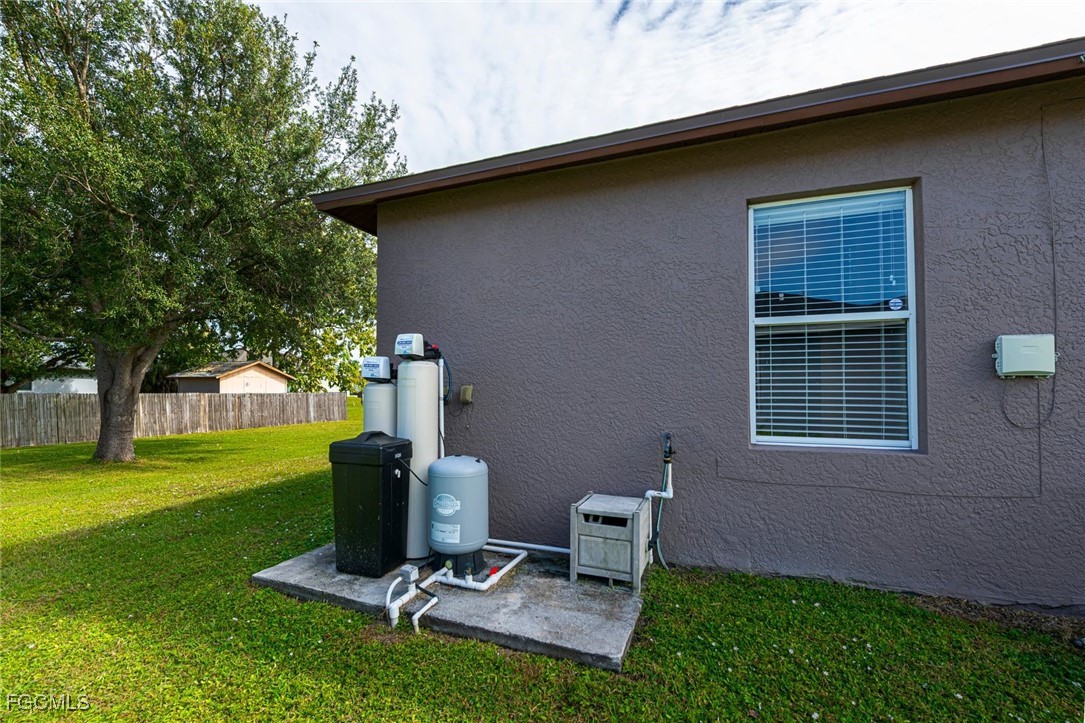 4108 13th Street Southwest Lehigh Acres, FL 33976 - Photo 43 of 48 a view of a backyard with table and chairs and a yard