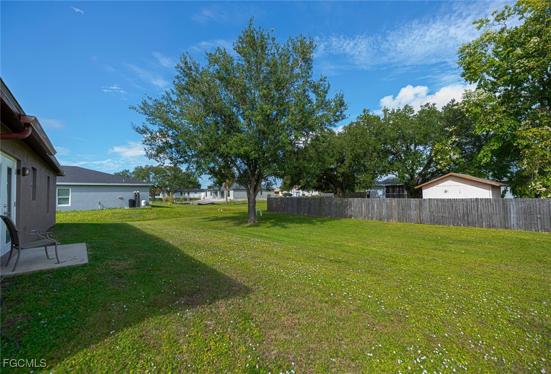 4108 13th Street Southwest Lehigh Acres, FL 33976 - Photo 44 of 48 a view of a house with a yard