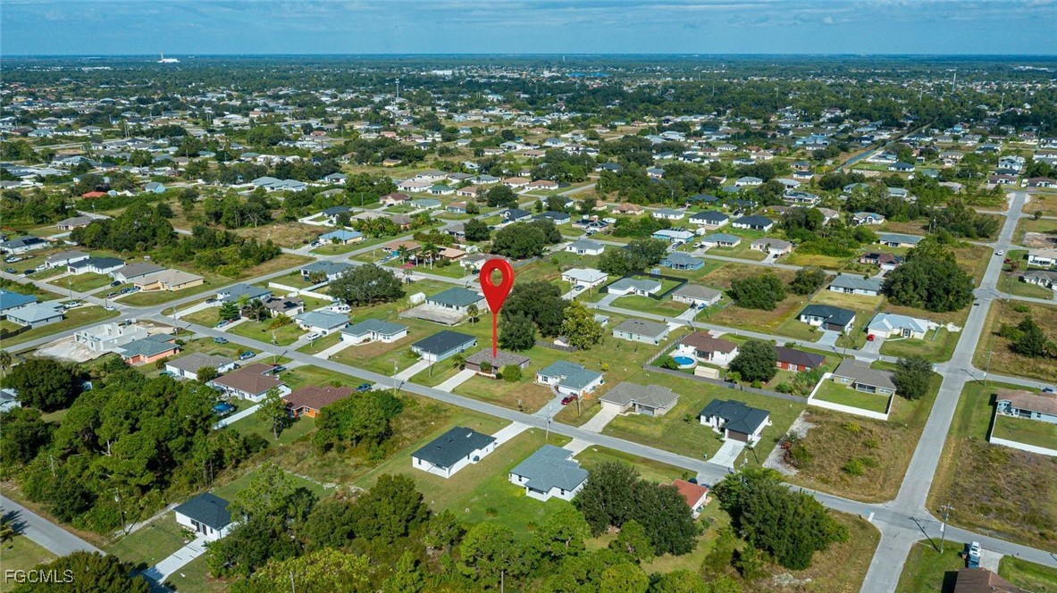 4108 13th Street Southwest Lehigh Acres, FL 33976 - Photo 46 of 48 an aerial view of residential houses with outdoor space and trees