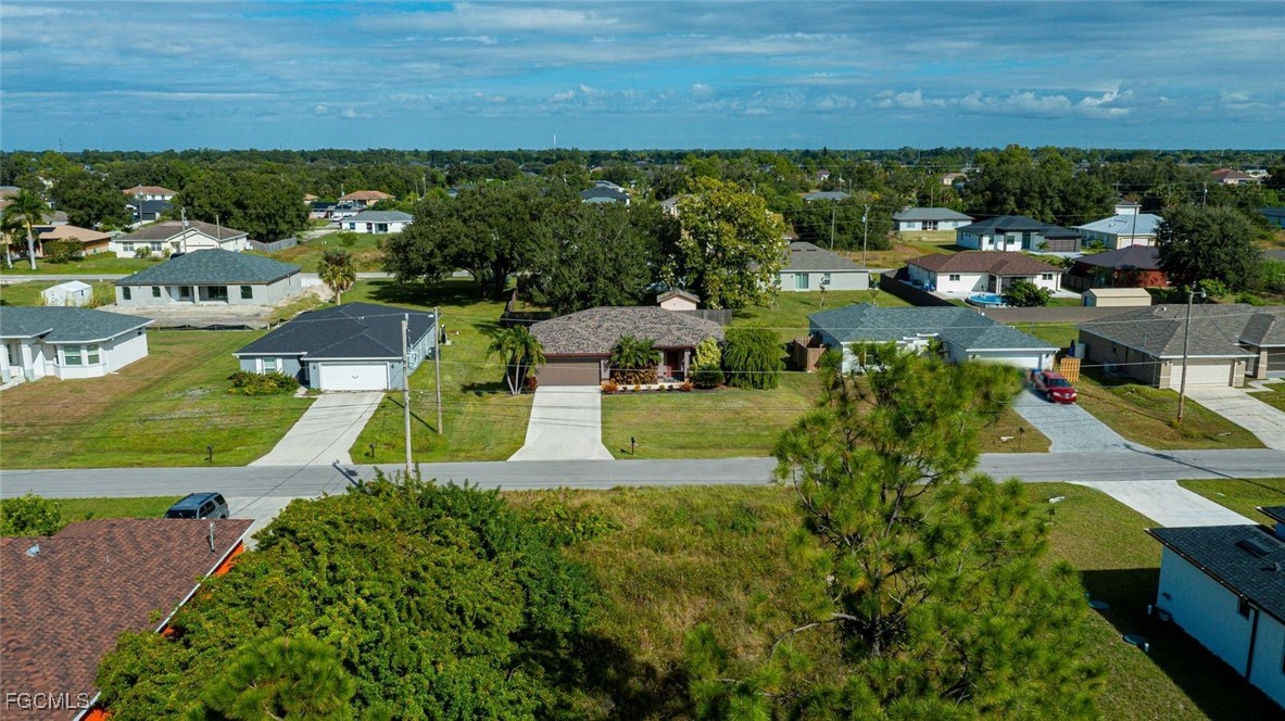 4108 13th Street Southwest Lehigh Acres, FL 33976 - Photo 47 of 48 an aerial view of a house with a garden