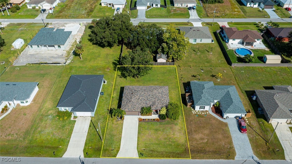 4108 13th Street Southwest Lehigh Acres, FL 33976 - Photo 48 of 48 an aerial view of a house with a swimming pool