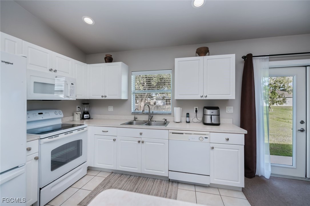 4108 13th Street Southwest Lehigh Acres, FL 33976 - Photo 5 of 48 a kitchen with cabinets stainless steel appliances and a window