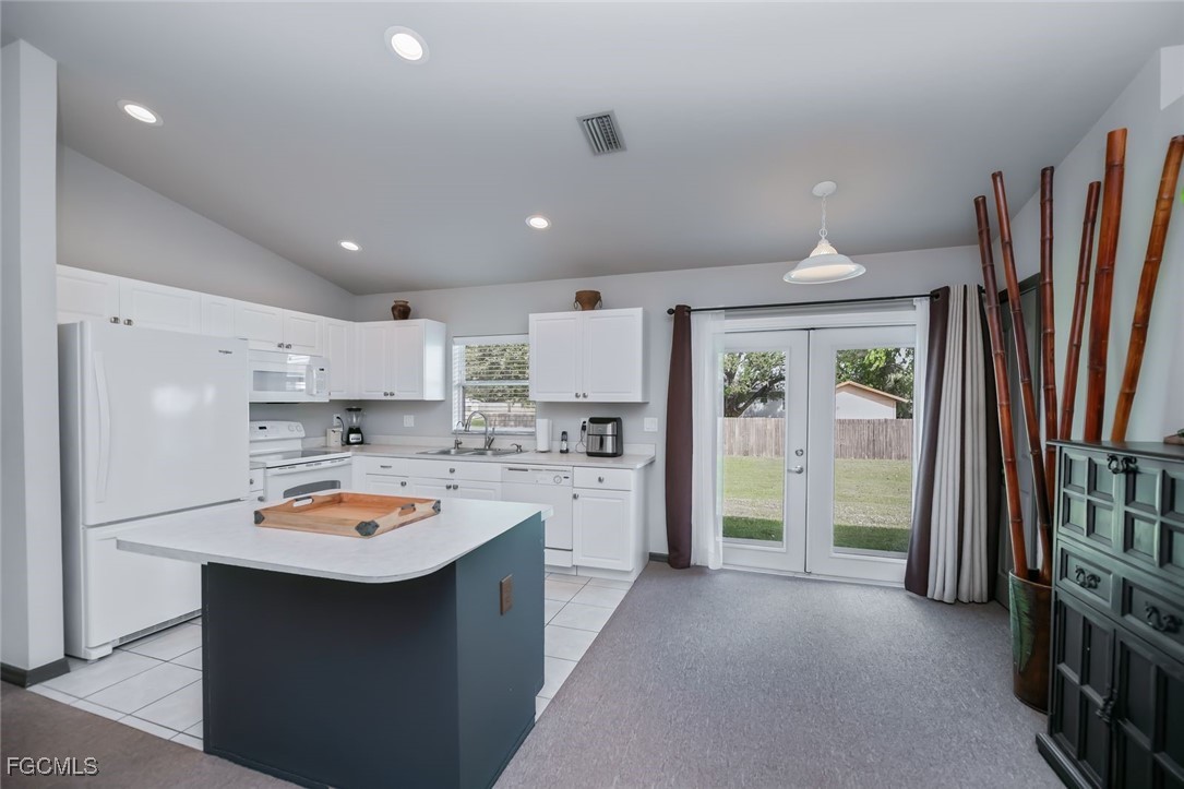 4108 13th Street Southwest Lehigh Acres, FL 33976 - Photo 6 of 48 a kitchen with stainless steel appliances granite countertop a refrigerator a sink dishwasher a stove and a refrigerator with wooden floor