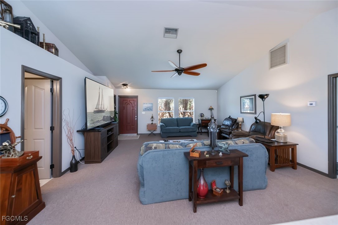 4108 13th Street Southwest Lehigh Acres, FL 33976 - Photo 8 of 48 a living room with furniture and a flat screen tv