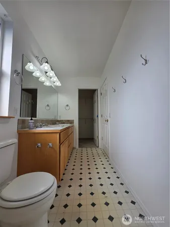 a bathroom with a toilet a sink and a mirror
