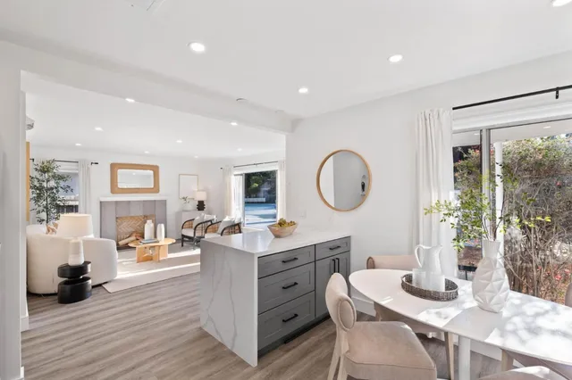 a living room with furniture a table and a large window