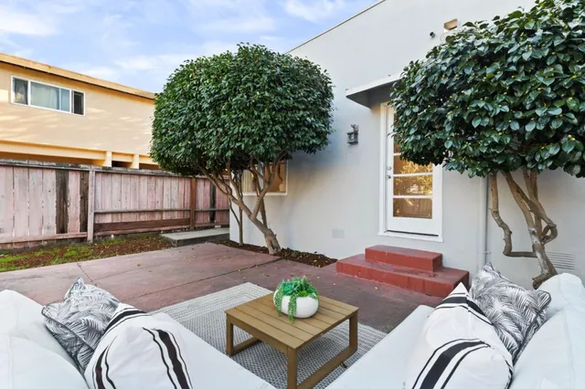 a view of a house with a yard and tree s