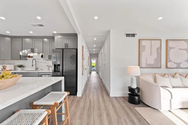 a kitchen with stainless steel appliances a refrigerator and a stove top oven