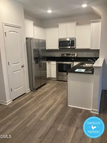 a kitchen with stainless steel appliances a refrigerator stove and microwave