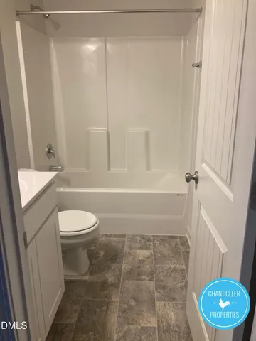a bathroom with a toilet a sink and shower