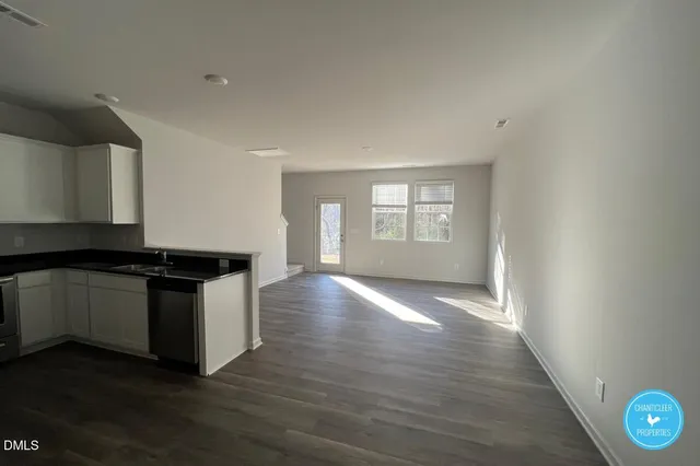a kitchen with granite countertop a stove and a large window