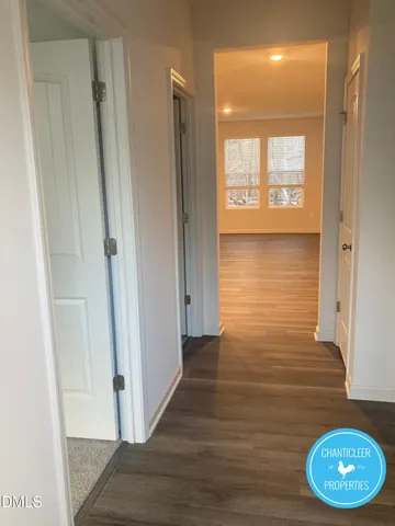 a view of a room with wooden floor and a window