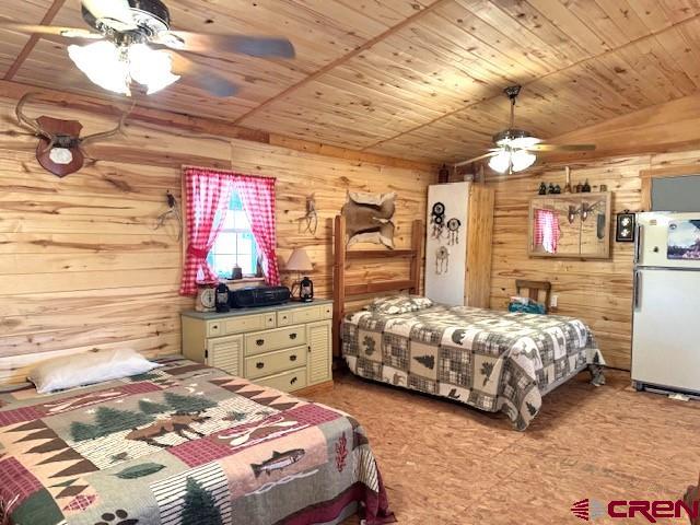12427 Rd G Cortez, CO 81321 - Photo 12 of 35 a bedroom with a bed and wooden cabinets