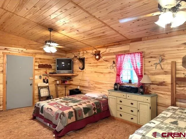 a bedroom with a bed and wooden cabinets