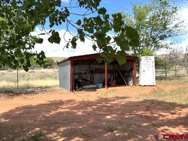 a view of a house with a tree in the background