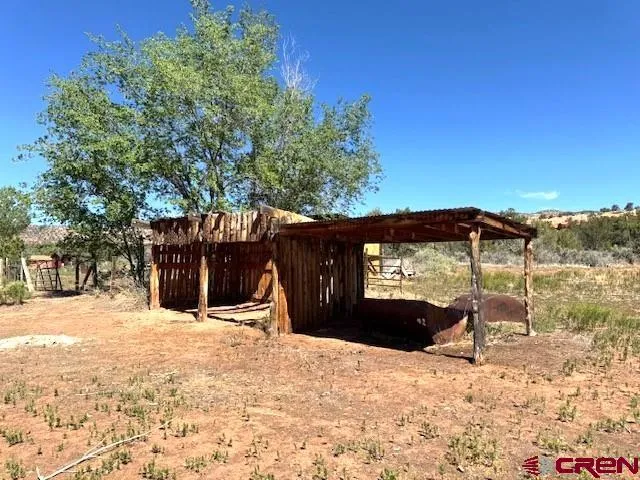 a view of a house with a yard covered in snow