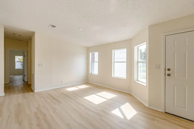 a view of a livingroom with wooden floor and a cabinet