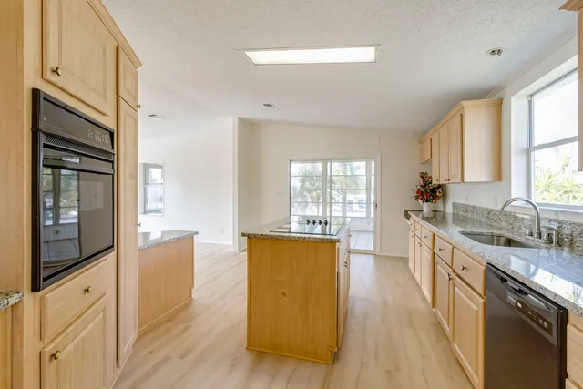 a kitchen with granite countertop a sink and a stove top oven