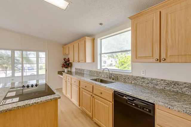 a kitchen with a stove a sink and a refrigerator