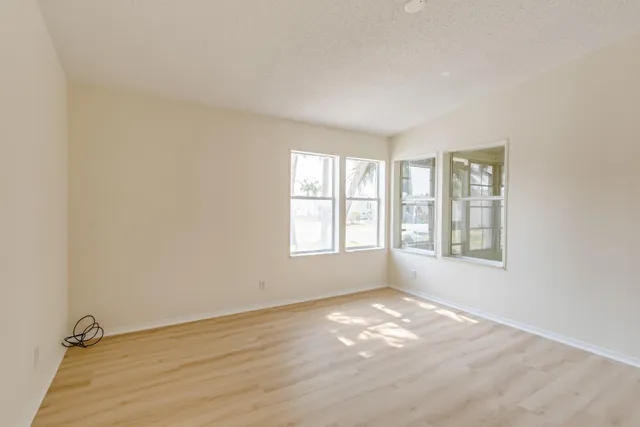 a view of empty room with wooden floor