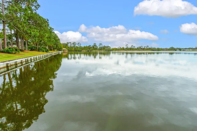 a living room with fireplace furniture and a large window