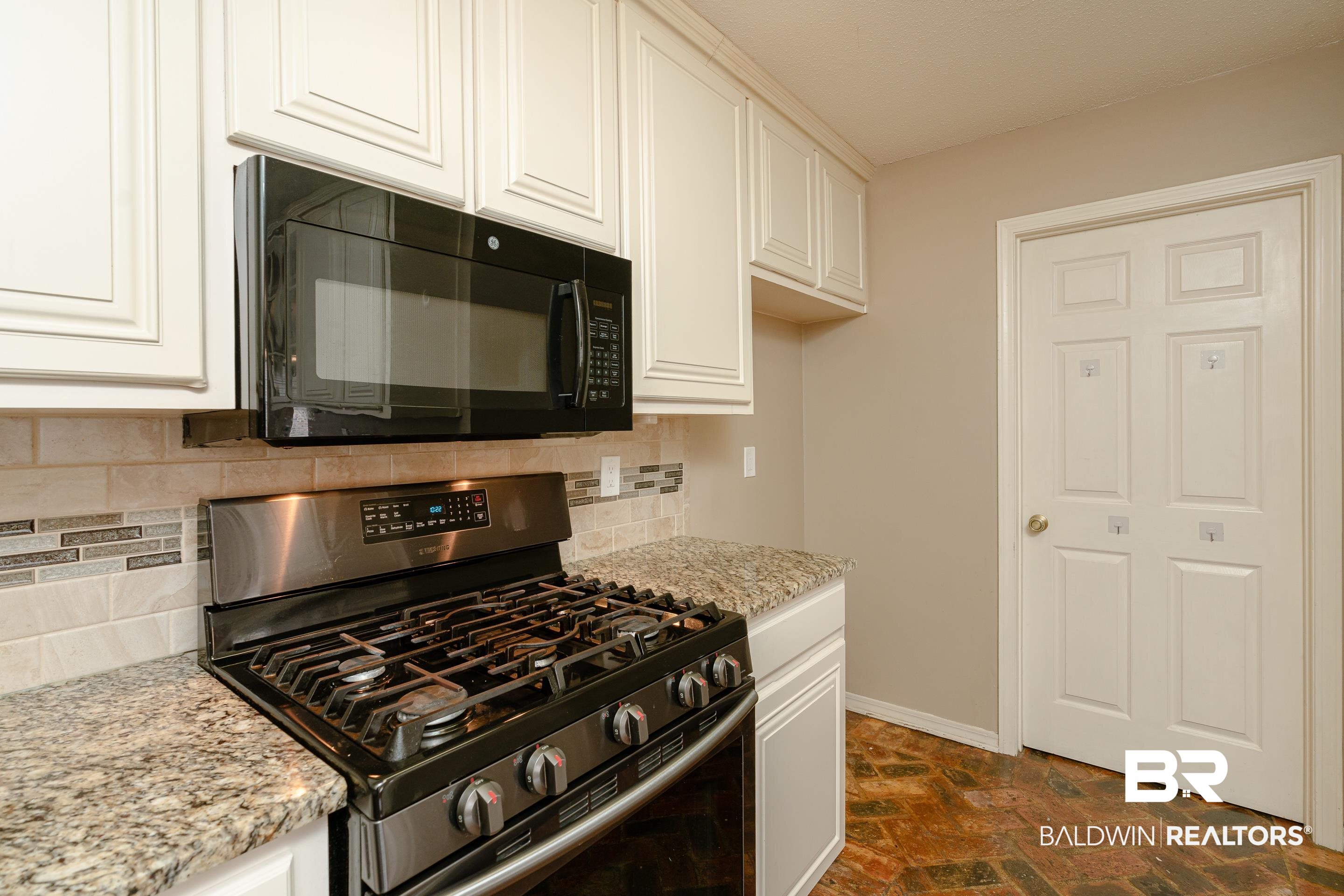 23 Old Mill Court Mobile, AL 36608 - Photo 15 of 37 Kitchen with white cabinets, tasteful backsplash, and stainless steel range with gas stovetop