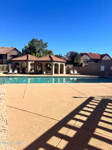 a view of swimming pool with furniture
