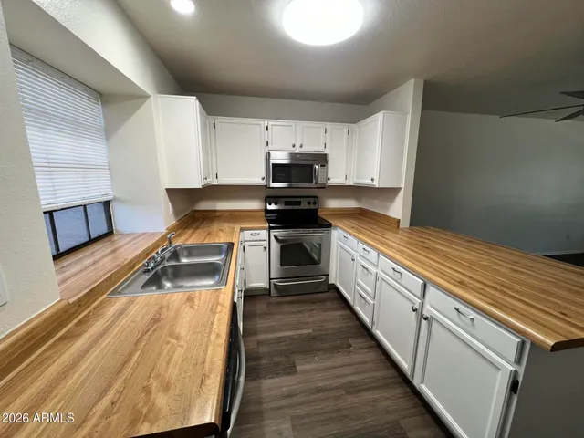 a kitchen with wooden cabinets and a sink