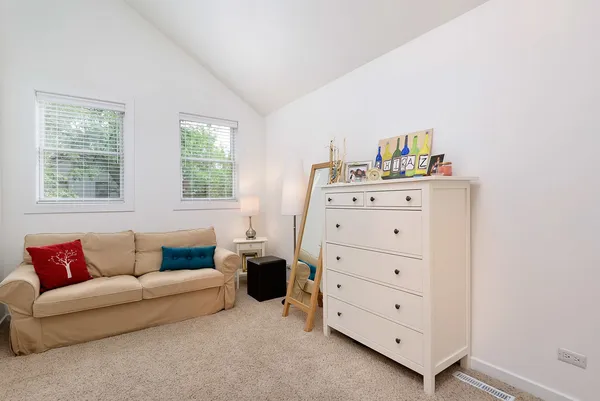 a living room with furniture and two window