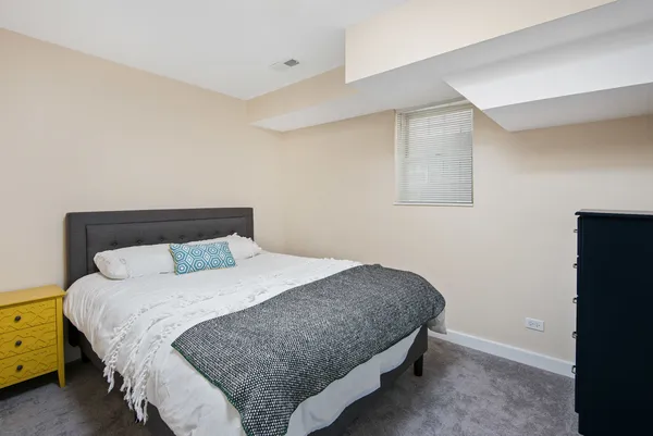 a bedroom with a bed and a dresser