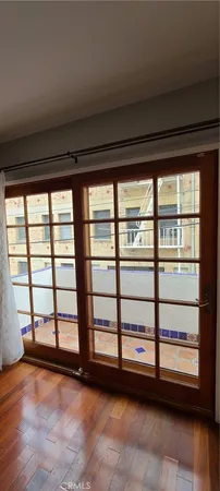 a view of a room with wooden floor