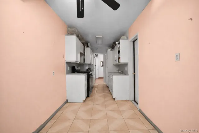 a view of a kitchen with a sink and a refrigerator