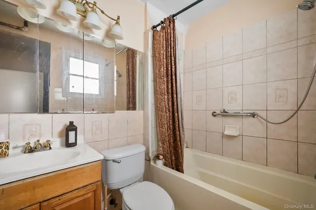 a bathroom with a sink toilet vanity and shower