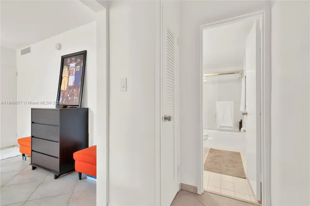 a hallway with a cabinet and mirror
