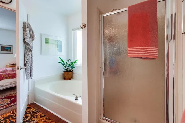 a bathroom with a tub and shower