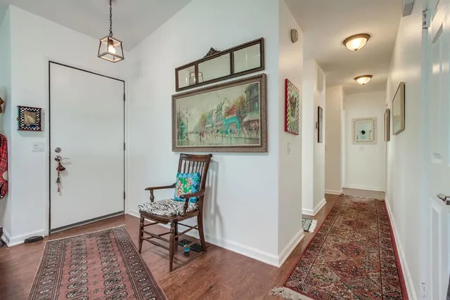 a view of a hallway and a livingroom with furniture