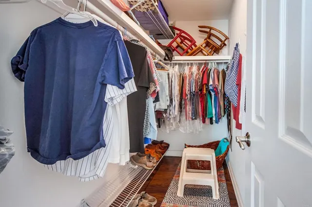 a view of walk in closet with clothes
